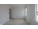 A bright, unfinished bedroom with white walls, trim, doors and a large window offering natural light at 17062 Cowbell Dr, Noblesville, IN 46060