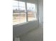 Bright bedroom featuring a large window with views of new construction, offering ample natural light at 17062 Cowbell Dr, Noblesville, IN 46060