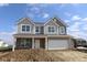 New construction home featuring gray siding, a brick facade, and an attached two-car garage at 17062 Cowbell Dr, Noblesville, IN 46060