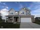 Beautiful two-story home featuring a two-car garage, covered front porch, and eye-catching curb appeal at 17062 Cowbell Dr, Noblesville, IN 46060