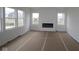 Bright living room featuring white walls, large windows, and a modern black fireplace at 17062 Cowbell Dr, Noblesville, IN 46060