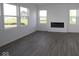 Bright living room with hardwood floors, modern fireplace and plenty of natural light from large windows at 17062 Cowbell Dr, Noblesville, IN 46060