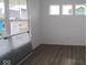 The living room features new hardwood floors, white walls, and three modern casement windows for great light at 17062 Cowbell Dr, Noblesville, IN 46060