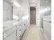 Bright bathroom featuring dual sinks, white cabinetry, quartz countertops, and a glass-enclosed shower at 19590 Wood Farm Pl, Westfield, IN 46074