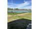 Scenic view of a pond surrounded by a grassy lawn and bordered by small pine trees in a residential area at 19590 Wood Farm Pl, Westfield, IN 46074