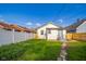 View of the backyard with grass and a white fence at 2034 Mansfield St, Indianapolis, IN 46202