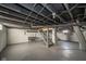 Unfinished basement features painted walls and ceiling with exposed beams and a staircase to the upper level at 2034 Mansfield St, Indianapolis, IN 46202