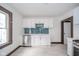 This is a bright kitchen with white cabinets and stainless steel appliances with updated tile backsplash at 2034 Mansfield St, Indianapolis, IN 46202