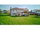Spacious backyard featuring a pristine lawn, outdoor seating, and covered pergola at 2215 Golfside Dr, Lebanon, IN 46052