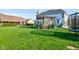 Well-manicured backyard featuring a stone pergola and lush, green lawn at 2215 Golfside Dr, Lebanon, IN 46052