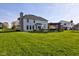 Spacious backyard with patio, pergola, outdoor seating, and mature trees at 2215 Golfside Dr, Lebanon, IN 46052