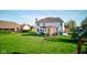 Beautiful backyard with a well-maintained lawn, covered patio, and serene setting at 2215 Golfside Dr, Lebanon, IN 46052