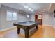 Spacious basement rec room with pool table, wet bar, and ample natural light from the window at 2215 Golfside Dr, Lebanon, IN 46052