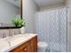 Bright bathroom featuring a stylish vanity with marble countertop and decorative shower curtain at 2215 Golfside Dr, Lebanon, IN 46052