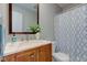 Cozy bathroom featuring a vanity with marble countertop, decorative floral arrangement and patterned shower curtain at 2215 Golfside Dr, Lebanon, IN 46052