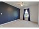 Bedroom featuring a deep blue accent wall and a window, creating a modern and calming retreat at 2215 Golfside Dr, Lebanon, IN 46052