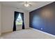 Bedroom featuring a blue accent wall and window, offering a cozy and stylish living space at 2215 Golfside Dr, Lebanon, IN 46052