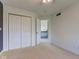 Bright bedroom with neutral carpet, white walls, and a closet, plus access to the hallway, offers a serene retreat at 2215 Golfside Dr, Lebanon, IN 46052