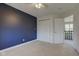 Bedroom featuring a blue accent wall, closet, and access to the hallway, providing a comfortable living space at 2215 Golfside Dr, Lebanon, IN 46052