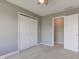 Bedroom featuring neutral carpet, white closet, and access to another room, offering versatile living space at 2215 Golfside Dr, Lebanon, IN 46052