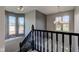 Bright entryway boasts natural light from windows, black staircase, and chandelier at 2215 Golfside Dr, Lebanon, IN 46052