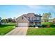 Charming two-story brick home with a well-manicured lawn and inviting front porch at 2215 Golfside Dr, Lebanon, IN 46052