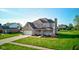 Beautiful two-story home featuring manicured lawn, attached garage, and charming front porch at 2215 Golfside Dr, Lebanon, IN 46052