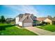 Lovely home with a well-maintained lawn, two-car garage, and inviting front porch at 2215 Golfside Dr, Lebanon, IN 46052