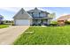 Charming two-story home with a well-manicured front lawn and attached two-car garage at 2215 Golfside Dr, Lebanon, IN 46052