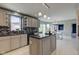 Open-concept kitchen features a center island, stainless appliances and tile backsplash at 2215 Golfside Dr, Lebanon, IN 46052
