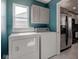 A functional laundry room includes a washer, dryer, and stainless steel refrigerator at 2215 Golfside Dr, Lebanon, IN 46052