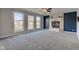 Bright living room with a fireplace, large windows, and a ceiling fan at 2215 Golfside Dr, Lebanon, IN 46052