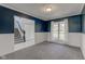 Open-concept living room with carpeted floors, white trim, and navy blue walls at 2215 Golfside Dr, Lebanon, IN 46052