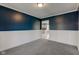 Picture of a living room featuring dark blue walls, gray carpet, and white trim at 2215 Golfside Dr, Lebanon, IN 46052