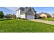 A bright lawn surrounds this lovely home with a big, attached garage at 2215 Golfside Dr, Lebanon, IN 46052