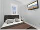 Simple bedroom with comfortable bed, neutral tones, and modern television at 230 E 9Th St # 401, Indianapolis, IN 46204