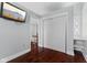 Bedroom featuring hardwood floors, closet space, and an entertainment center with a mounted TV at 230 E 9Th St # 401, Indianapolis, IN 46204