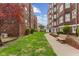 Beautiful courtyard with a walkway between buildings and a bench along the path, as well as trees and greenery at 230 E 9Th St # 401, Indianapolis, IN 46204