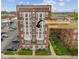 Brick apartment building featuring bright windows and mature landscaping with a corner unit highlighted at 230 E 9Th St # 401, Indianapolis, IN 46204
