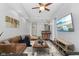 Comfortable living room with an adjacent breakfast bar, ceiling fan, and sleek flooring at 230 E 9Th St # 401, Indianapolis, IN 46204