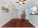 Open-concept living space features hardwood floors, a ceiling fan, and a bar area with seating at 230 E 9Th St # 401, Indianapolis, IN 46204