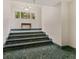 Interior shot of a stairwell with green granite steps leading to an upper floor, lit by an overhead chandelier at 230 E 9Th St # 401, Indianapolis, IN 46204
