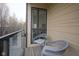 Cozy balcony featuring glass railing, wood decking, and two comfortable chairs at 233 E Saint Joseph St # 2G, Indianapolis, IN 46202