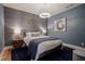 Beautiful bedroom featuring blue walls, area rug, and unique lighting at 233 E Saint Joseph St # 2G, Indianapolis, IN 46202