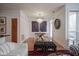Elegant dining room with a chandelier, modern art, hardwood floors, and a view to the living room and kitchen at 233 E Saint Joseph St # 2G, Indianapolis, IN 46202