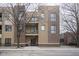 Modern multi-story condo building with brick and siding facade and upper level balcony at 233 E Saint Joseph St # 2G, Indianapolis, IN 46202