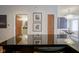 Modern kitchen with a black granite countertop, stainless steel appliances and a view to the dining room and bathroom at 233 E Saint Joseph St # 2G, Indianapolis, IN 46202