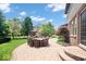 Relaxing backyard featuring a brick-paved patio, outdoor seating, green lawn, and mature trees at 2705 April Springs View, Carmel, IN 46074