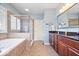Modern bathroom with a soaking tub, tiled shower with glass door, and granite countertops at 2705 April Springs View, Carmel, IN 46074