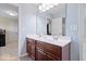 Bathroom featuring a double sink vanity with wood cabinets and large mirror under pastel blue paint at 2705 April Springs View, Carmel, IN 46074